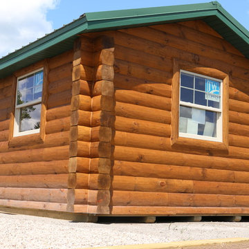 Tiny cabin with half log siding and butt-n-pass corners