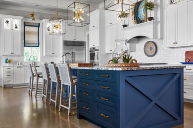 Eat-in kitchen - large coastal u-shaped dark wood floor and brown floor eat-in kitchen idea in Charleston with an undermount sink, white cabinets, white backsplash, subway tile backsplash, stainless steel appliances and an island