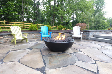 Patio - mid-sized traditional backyard stone patio idea in Philadelphia with a fire pit and no cover