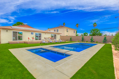 Large transitional backyard concrete and rectangular lap hot tub photo in Orange County