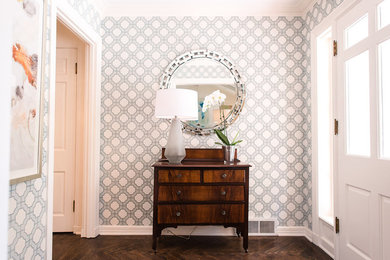 Mid-sized transitional medium tone wood floor and brown floor entryway photo in Austin with white walls and a white front door