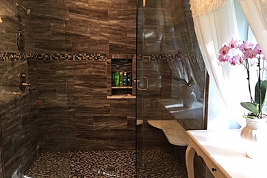Bathroom - traditional brown tile and ceramic tile ceramic tile and beige floor bathroom idea in Cleveland with furniture-like cabinets, medium tone wood cabinets, a one-piece toilet, a drop-in sink, granite countertops and a hinged shower door