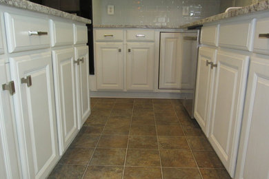 Mid-sized transitional l-shaped eat-in kitchen photo in DC Metro with raised-panel cabinets, white cabinets and an island