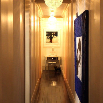 Gallery hallway with a portrait of Mick Jagger over a serene white milk glass bu
