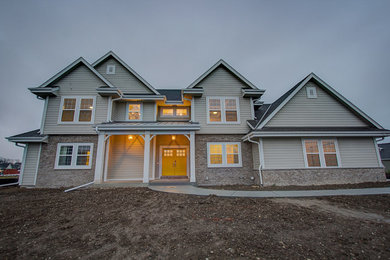 Example of a huge transitional beige two-story concrete fiberboard gable roof design in Milwaukee