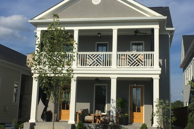 Large transitional gray two-story stucco exterior home photo in Louisville with a shingle roof