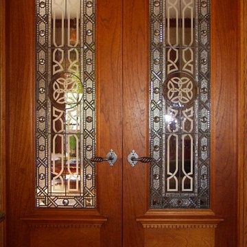 Etched and beveled leaded glass doors.