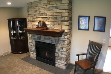 Design ideas for a mid-sized traditional family room in Cleveland with a standard fireplace and a stone fireplace surround.