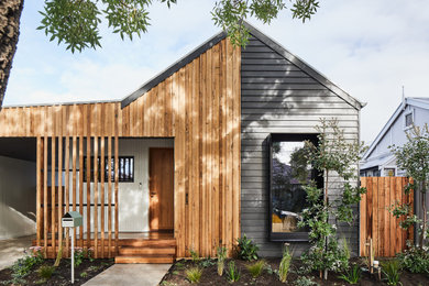 This is an example of a contemporary one-storey multi-coloured house exterior in Melbourne with a gable roof.
