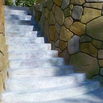 Acid etched stairs with custom carved & stained rock retaining walls