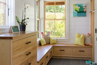 Mudroom - farmhouse ceramic tile and gray floor mudroom idea in Burlington with white walls