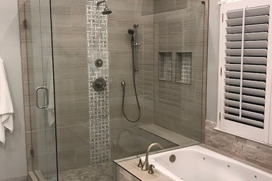 Bathroom - large master beige tile and porcelain tile bathroom idea with shaker cabinets, gray walls and a hinged shower door