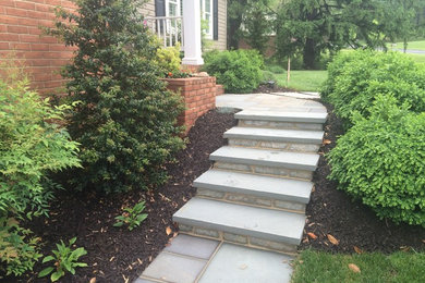 Inspiration for a large timeless white two-story brick exterior home remodel in Baltimore with a clipped gable roof