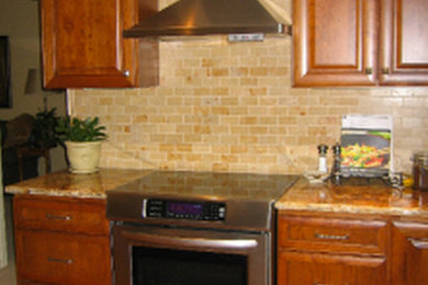 Example of a mid-sized l-shaped medium tone wood floor eat-in kitchen design in Denver with an undermount sink, raised-panel cabinets, medium tone wood cabinets, granite countertops, stainless steel appliances and an island