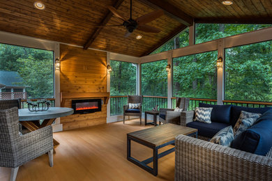 Example of a large transitional backyard patio design in Atlanta with decking and a roof extension