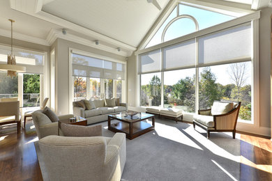 Inspiration for an expansive transitional open concept living room in Toronto with medium hardwood floors, grey walls, no tv and brown floor.