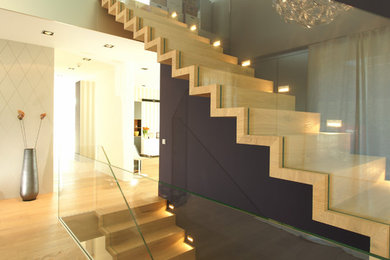 Example of a large minimalist wooden straight staircase design in Other with wooden risers