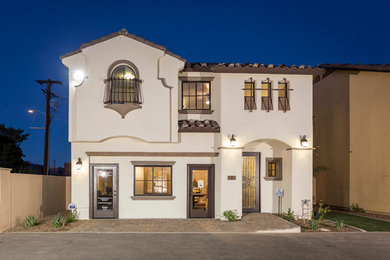 Mid-sized mediterranean two-storey stucco beige exterior in Phoenix with a gable roof.