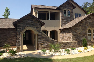 Large traditional beige two-story mixed siding gable roof idea in Other