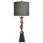 StyleCraft Home Collection - Vintage Gold, Black Base Contemporary Table Lamp - A striking and sophisticated contemporary table lamp with a tall presence and unique elements. This fixture uses a set of nugget-like vintage gold finish accents on a squared black base to give its polyresin body an unmatched power and boldness. To give it a complete look, this lamp is topped with a round hardback shade for a classic appeal.