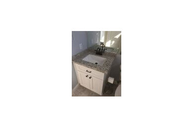 Inspiration for a small modern 3/4 bathroom remodel in Las Vegas with raised-panel cabinets, beige cabinets, a drop-in sink, granite countertops and beige countertops