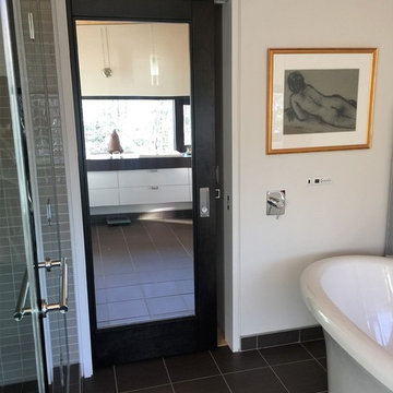 Glass sliding bathroom door lets the natural light in