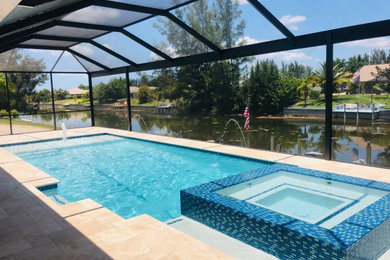 Inspiration for a mid-sized coastal backyard stone and rectangular pool remodel in Miami