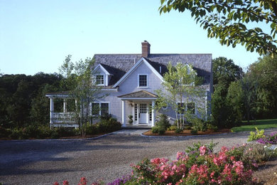 Example of a beige two-story gable roof design in Boston