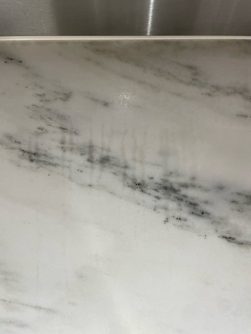 steam/water marks on marble backsplash