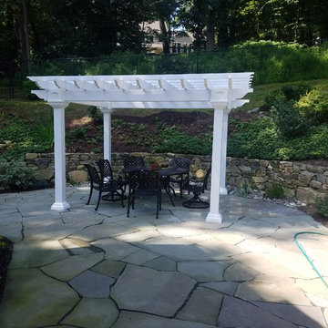Backyard irregular patio with pergola and lighting