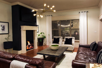 Transitional medium tone wood floor living room photo in Little Rock with white walls, a standard fireplace and a wall-mounted tv