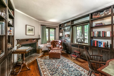 Inspiration for a large craftsman freestanding desk dark wood floor and brown floor study room remodel in Kansas City with gray walls, a standard fireplace and a brick fireplace