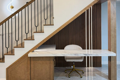 Inspiration for a small cottage built-in desk porcelain tile, gray floor, vaulted ceiling and wall paneling study room remodel in Houston with brown walls and a brick fireplace