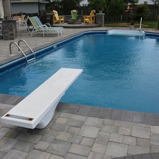 Large traditional backyard patio in Chicago with concrete pavers.