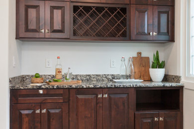 Small cottage single-wall wet bar photo in Other with raised-panel cabinets, dark wood cabinets and quartz countertops