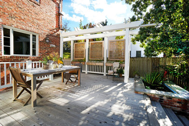 Example of a mid-sized transitional backyard patio design in DC Metro with a pergola