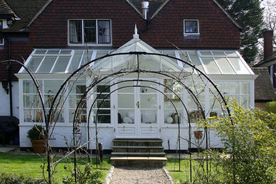 Sevenoaks, tubular metal pergola set on central axis of conservatory for access