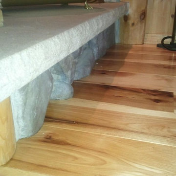 Rustic Hickory Flooring scribed by hand to the fireplace hearth