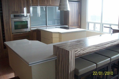 Eat-in kitchen - large contemporary l-shaped dark wood floor and brown floor eat-in kitchen idea in Other with an undermount sink, beaded inset cabinets, dark wood cabinets, stainless steel appliances, a peninsula and quartz countertops