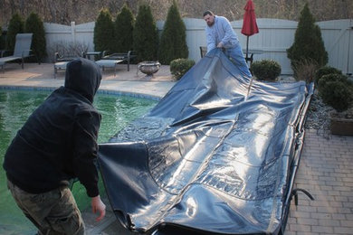 Backyard brick and custom-shaped pool photo in Detroit