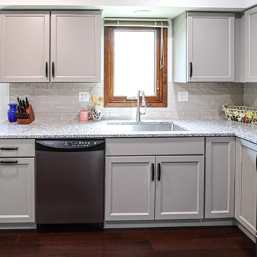 Gray Kitchen with Luna Pearl Granite Countertop and Taupe Tile Backsplash