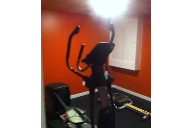 Inspiration for a small modern carpeted multiuse home gym remodel in Other with orange walls