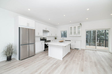 Kitchen - mid-sized kitchen idea in DC Metro with shaker cabinets, white cabinets, quartzite countertops, white backsplash, an island and white countertops