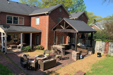 Design ideas for a mid-sized country backyard patio in Nashville with an outdoor kitchen, concrete pavers and a gazebo/cabana.