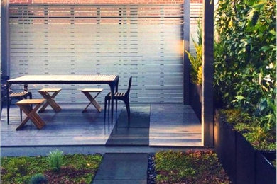 Design ideas for a contemporary partial sun rooftop stone landscaping in New York.