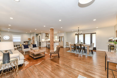 Living room - mid-sized craftsman open concept medium tone wood floor and brown floor living room idea in Charlotte with gray walls and no fireplace