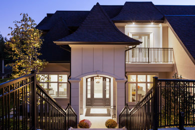 Inspiration for a large transitional three-storey house exterior in Vancouver.
