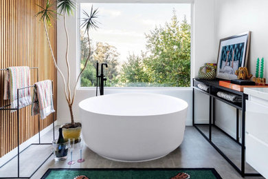 Example of a large minimalist master white tile and ceramic tile ceramic tile, double-sink and wood wall bathroom design in San Francisco with flat-panel cabinets, white cabinets, a one-piece toilet, white walls, a vessel sink, a hinged shower door and a floating vanity