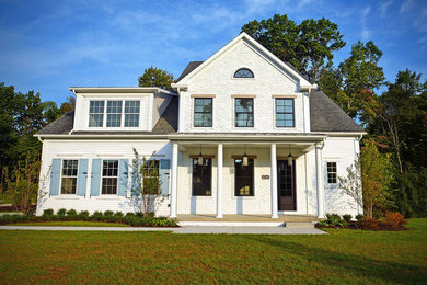 Design ideas for a two-storey white exterior in Cleveland with mixed siding.