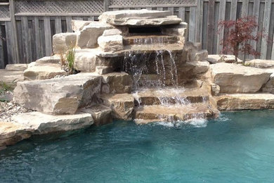 Pool fountain - mid-sized transitional backyard stamped concrete and custom-shaped natural pool fountain idea in Toronto